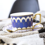 Decorative Tea Cup Set featuring Gold Handles and Matching Saucers