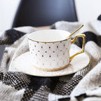 Decorative Tea Cup Set featuring Gold Handles and Matching Saucers