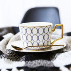 Decorative Tea Cup Set featuring Gold Handles and Matching Saucers